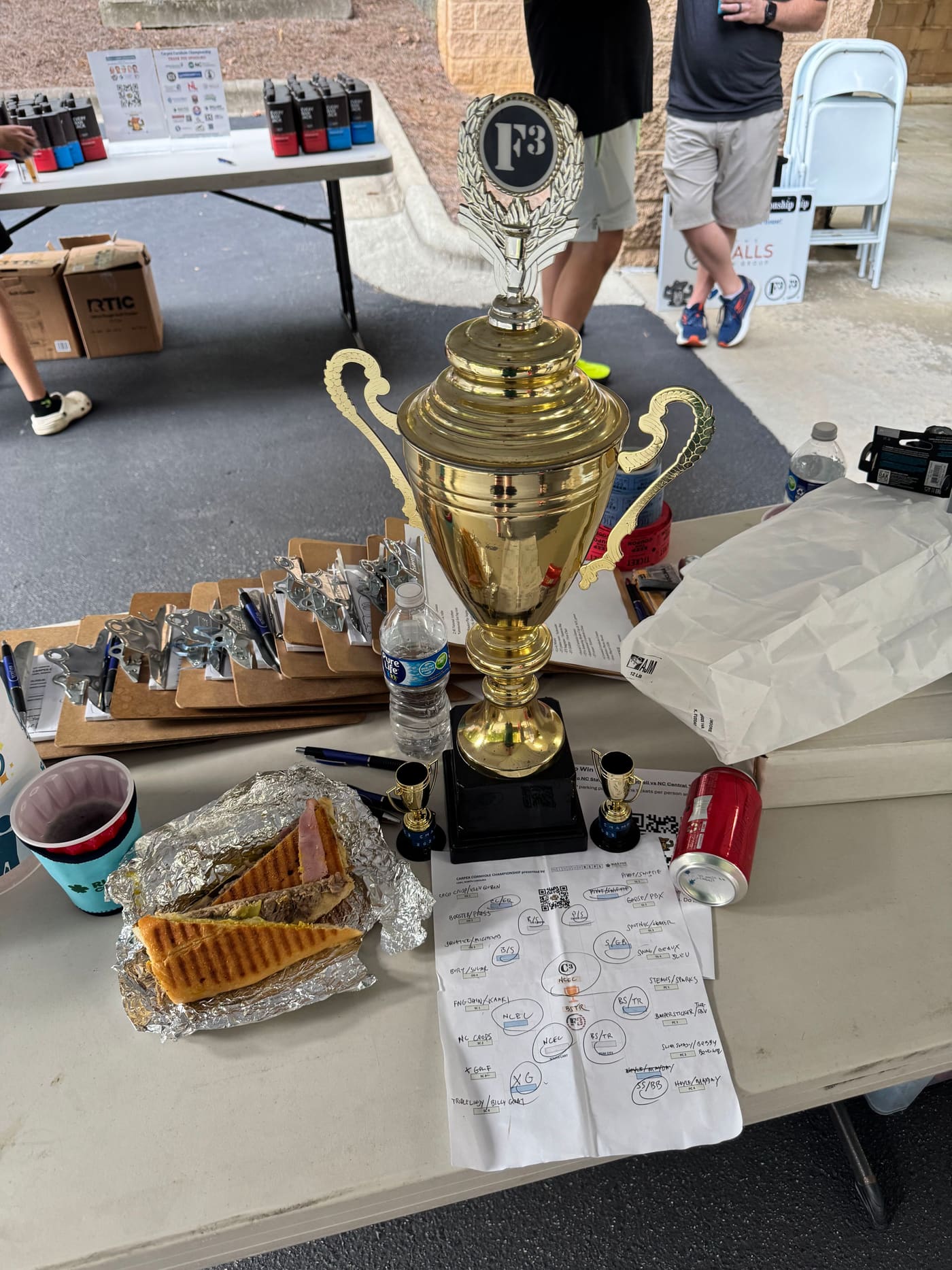 The Carpex Cornhole Championship trophy at the registration table
