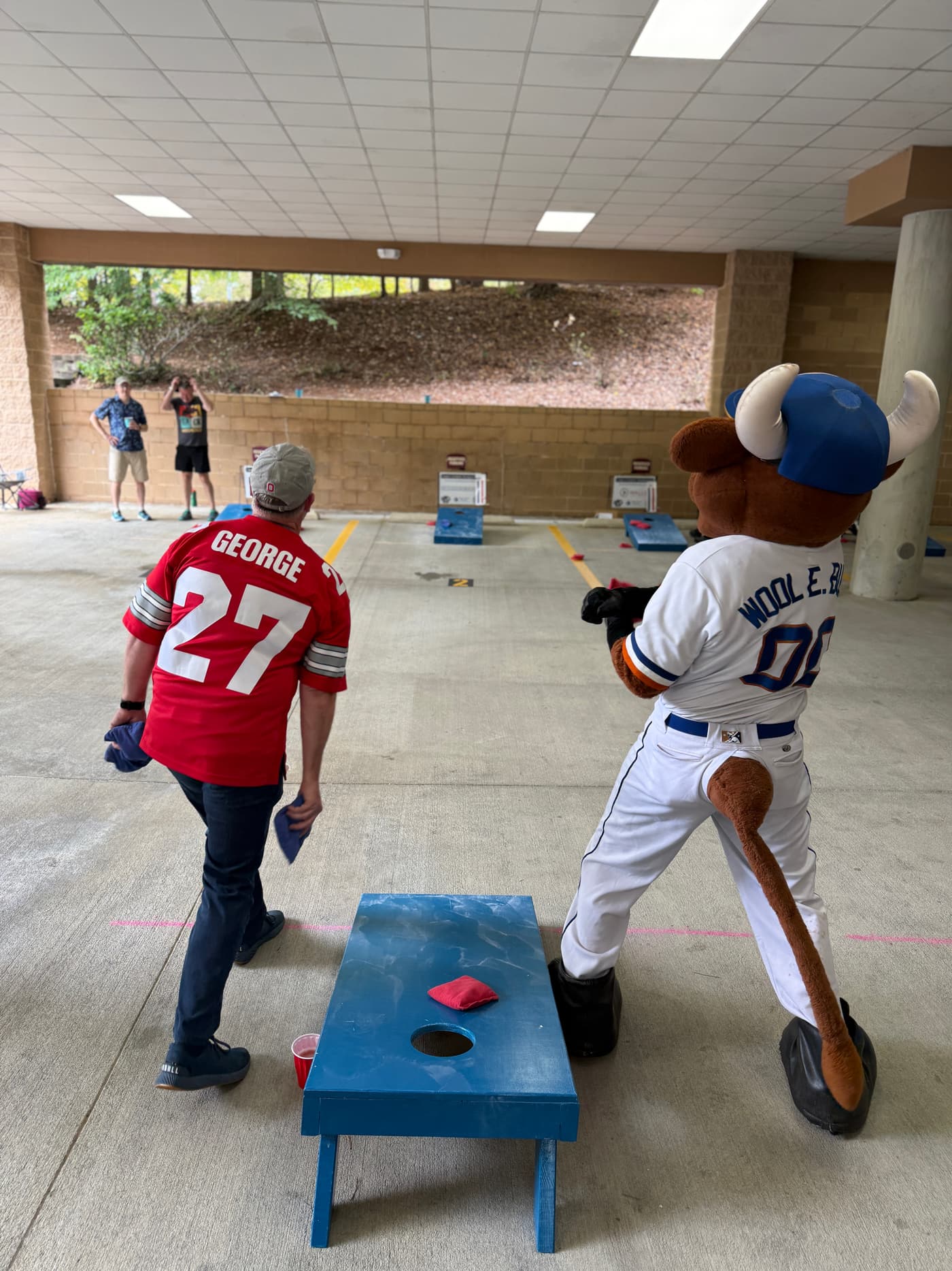 Wool E. Bull of the Durham Bulls throwing bags against a competitor at the 2025 championship